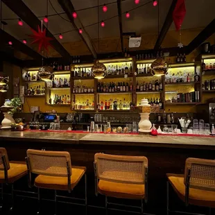 a row of chairs at a bar