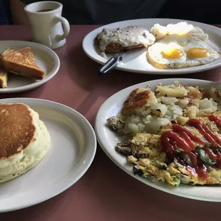 Supreme omelette with hash browns and pancakes, chicken with gravy with grits and French toast