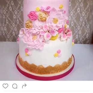 a white cake with pink and yellow flowers