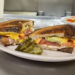 a sandwich with pickles on a plate