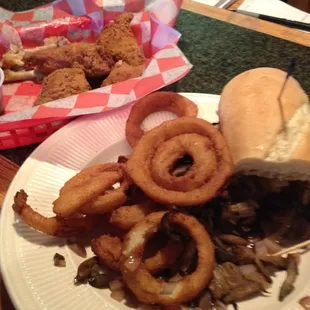 a sandwich and onion rings on a plate
