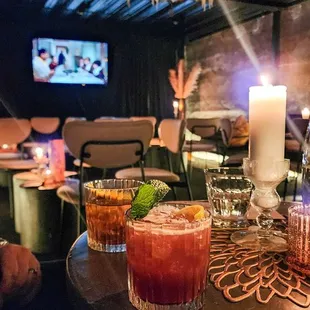a table with drinks and candles