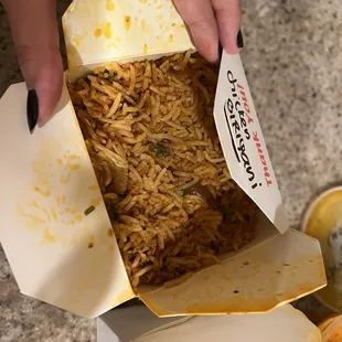 a person opening a box of food