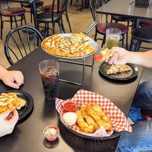 people eating pizza and fries