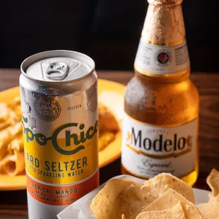 a beer, chips, and a bowl of quesadilla