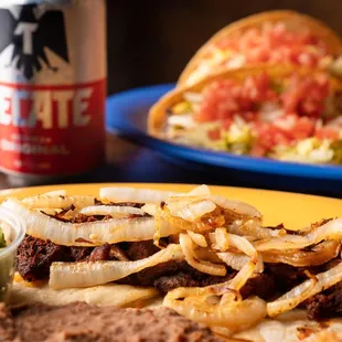a plate of food and a can of beer