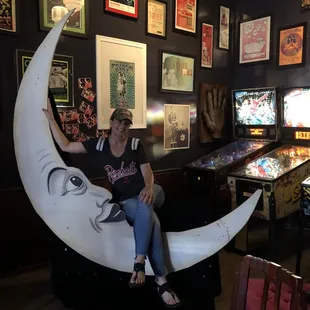 a woman sitting on a half moon