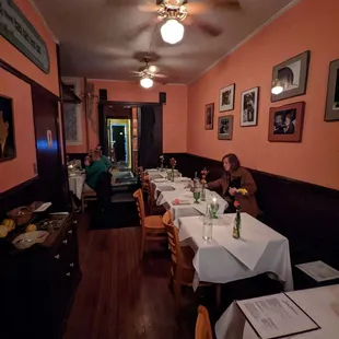a woman sitting at a table in a restaurant