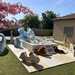 White, blue and tan package with balloons and stuffed animals available for rent today.