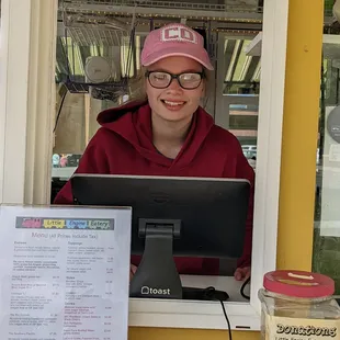 a woman sitting behind a laptop