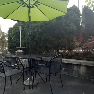a patio with tables and umbrellas