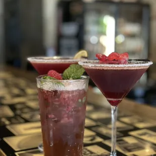 two cocktails on a bar