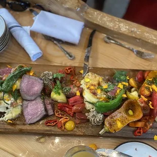 Charcuterie board with meat, cheesy potatoes, roasted butternut squash, peppers, etc.  So good!