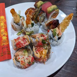 a plate of sushi and a red packet