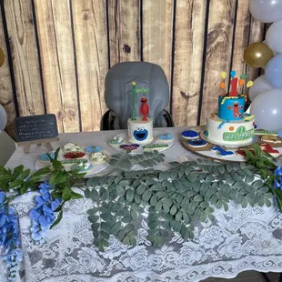 a table with a cake and balloons