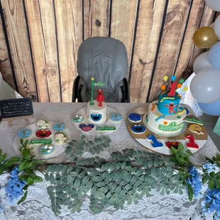 a table with a cake and balloons
