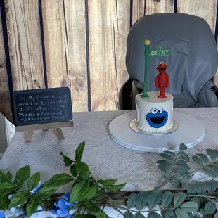 a table with a cake and flowers