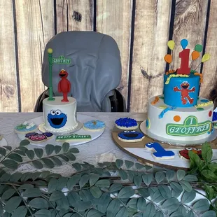 a table with a cake and cupcakes
