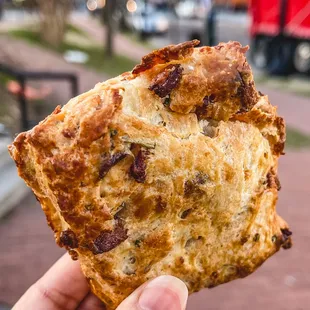a hand holding a piece of bread