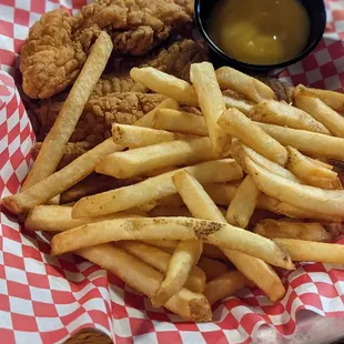 a basket of fried chicken and french fries