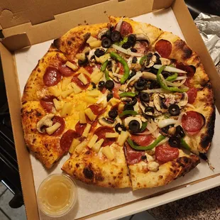 Half supreme extra mushrooms, extra cheese, Half pepperoni extra pepperoni, pineapple extra cheese. Questionable to say the least.
