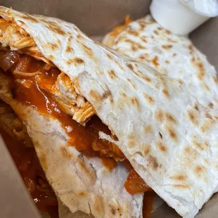 a chicken quesadilla with sauce