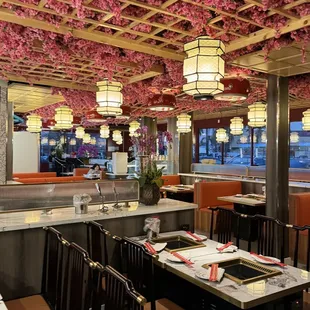 a dining area with cherry blossoms on the ceiling