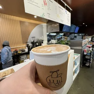 a hand holding a cup of coffee