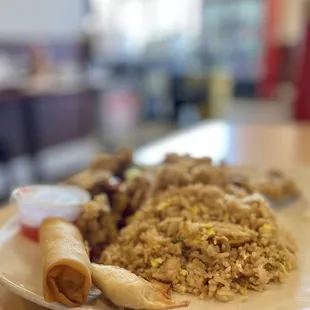 a plate of food with rice and meat