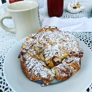 a pastry on a plate with powdered sugar