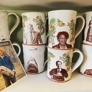 a collection of coffee mugs on a shelf