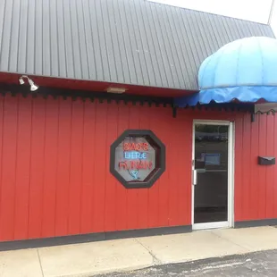 a red building with a blue umbrella