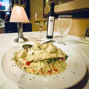 This evenings special. Barramundi with a caper artichoke sauce layered over aioli capellini and sautéed spinach. Heavenly!