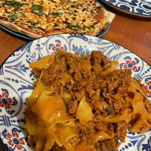 a plate of pasta and a pizza