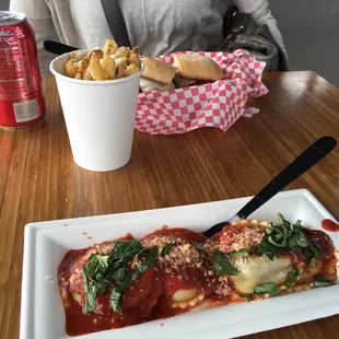 a woman sitting at a table with a plate of food