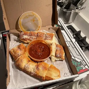 Cheesy Bread Sticks served with marinara sauce on the side