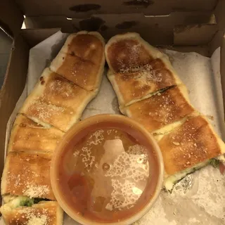 Pesto Bread Sticks served with marinara sauce on the side