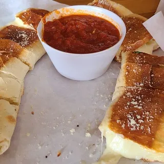 Cheese garlic bread served with marinara sauce on the side