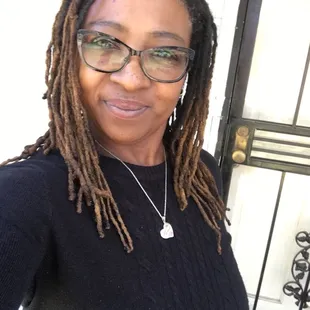 a woman with dreadlocks and glasses