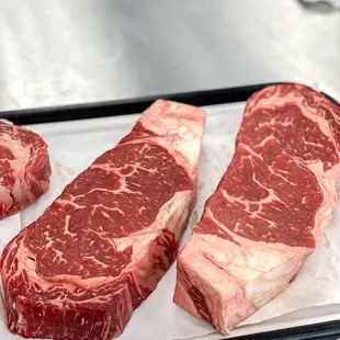 three steaks on a tray