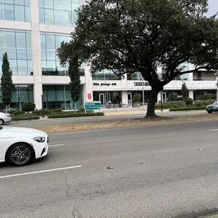 a white car driving down the street