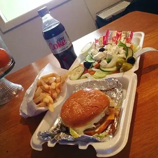 Greek burger. French fries. Greek salad. Diet coke.