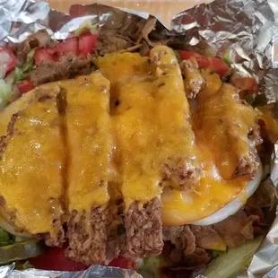 Steak in the sack meat, american cheese, gouda cheese, cheddar cheese, hamburger patty, bacon, lettuce, tomato, pickles, onions, and mayo