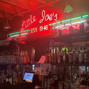 a neon sign above the bar