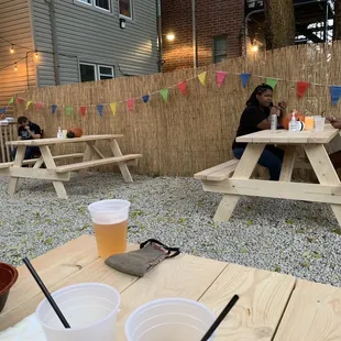 two women sitting at a picnic table