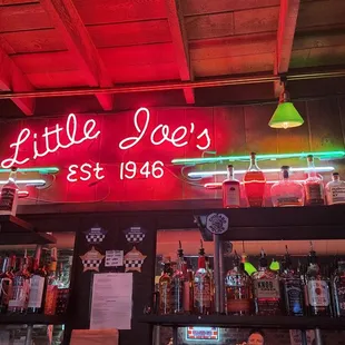 a neon sign above the bar