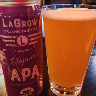 a glass of beer and a can of lagrow