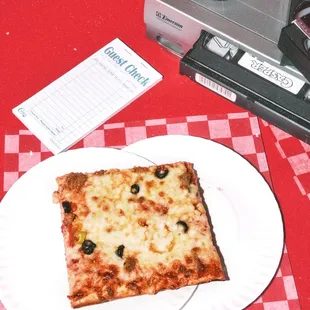 a slice of pizza on a plate