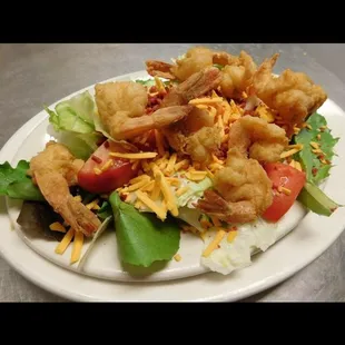 a salad with shrimp and lettuce