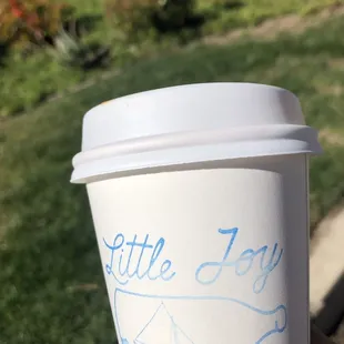 a hand holding a cup of coffee